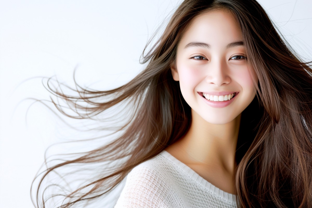 白く形の整った歯を見せて笑う女性