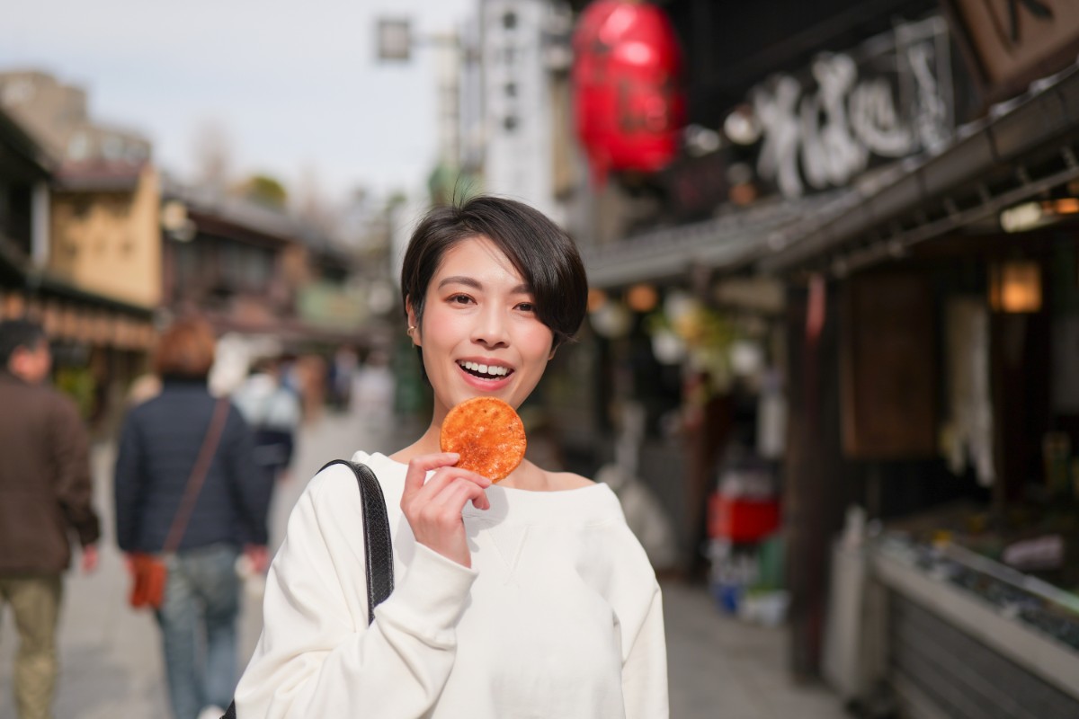 硬い煎餅を食べる女性